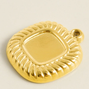 Macro view of square gold pendant with twisted rope border for DIY jewelry making