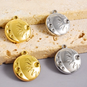 Close-up of gold and silver sun relief pendants for DIY jewelry accessories and necklaces