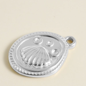 Macro shot of silver scallop shell relief pendant made of 304 stainless steel