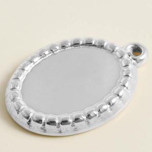Close-up of beaded edge oval pendant base in 304 stainless steel for DIY jewelry