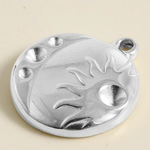 Macro view of 304 stainless steel celestial pendant with sun and moon relief carvings