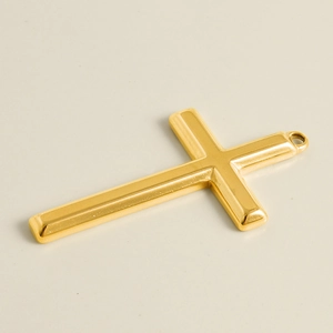 Detailed close-up of a polished golden stainless steel cross pendant for DIY jewelry design
