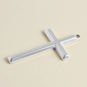 Detail of 304 stainless steel cross pendant with polished finish and recessed design