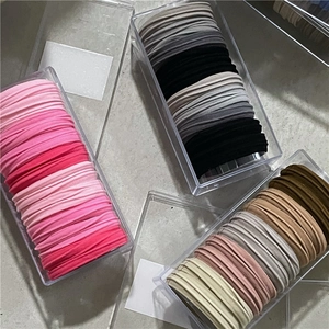 Colorful high-elasticity hair ties neatly organized in transparent acrylic storage boxes