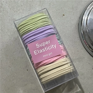 Macro shot of colorful seamless elastic hair bands in a transparent storage box