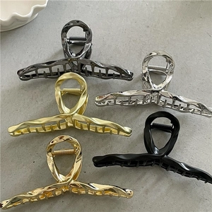 Detailed overhead view of five metallic liquid-style claw clips in various elegant finishes
