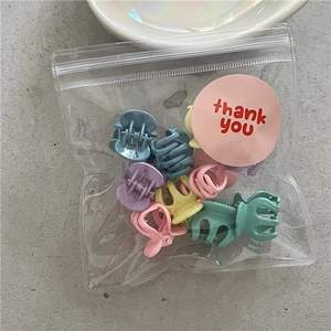 Detailed view of 10pcs macaron flower mini hair claws in a thank you ziplock bag