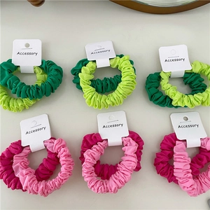 Detail of satin scrunchies sets with pleated texture and stylish contrast colors