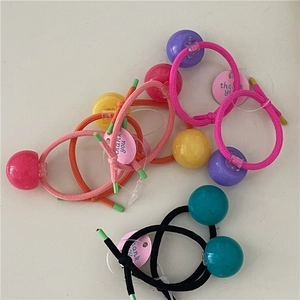 Detailed view of colorful glossy plastic beads on high-elasticity braided hair ties