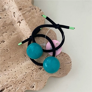 Close-up of dual high-elastic black hair ties with smooth cyan resin bead ornaments