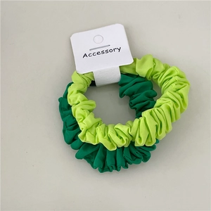 Detail of green and neon fabric scrunchies set with wavy texture on display card