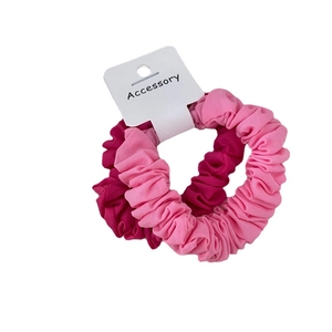 Two-pack set of pleated fabric scrunchies in light and rose pink with display card