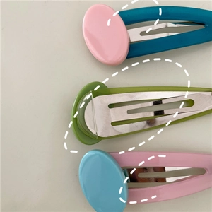 Close-up of three candy-colored oval BB hair clips with jelly texture contrast patches