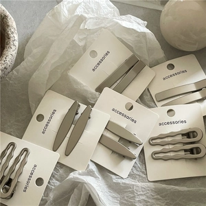 Minimalist matte metallic geometric hair clips in various shapes on display cards