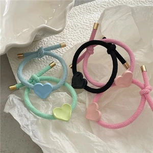 Pastel heart elastic hair ties in pink, blue, black, and mint with gold accents