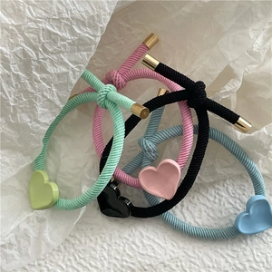Set of four colorful elastic heart hair ties in mint green, pink, black, and sky blue