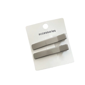 Pair of minimalist silver-toned geometric rectangular metal hair clips on white card