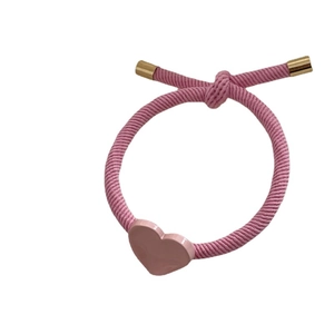 Pink braided hair tie with glossy heart charm and gold-toned metal tips for ponytail