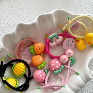 Colorful set of kids fruit hair ties featuring cute strawberry and cherry resin charms