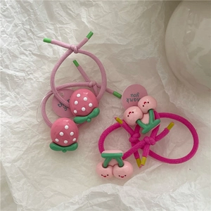 Detail of cute strawberry and cherry hair ties with elastic bands for kids accessories