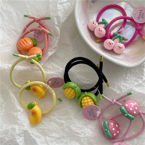 Detail shot of colorful elastic hair ties featuring cute 3D resin fruit pendants