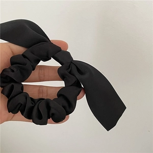 Elegant black ribbon bow scrunchie with long streamers made of silky satin fabric