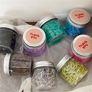 Colorful elastic hair band set in clear plastic jars with silver metal lids and thank you stickers