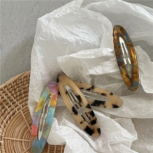 Elegant oval acetate hair clips in four tortoise and marbled patterns with silver metal clips