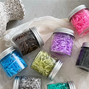 Colorful elastic hair bands set stored in a transparent jar with a silver screw lid