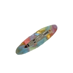 Elegant oval acetate hair clip featuring colorful marble texture with a silver metal base