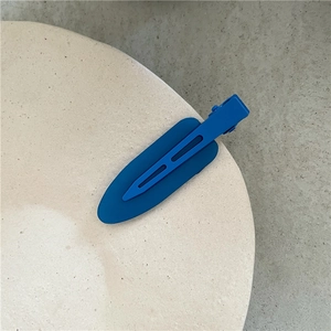 Close-up of Klein blue jelly hair clip with matte finish and hollow oval design
