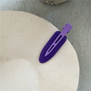 Detailed macro view of purple matte jelly hair clip with hollow design and smooth texture