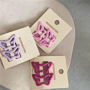 Detailed view of colorful hollow butterfly hair clips in purple, pink and rose colors
