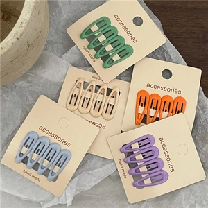 Set of macaron-colored teardrop snap hair clips in matte finish on card packaging