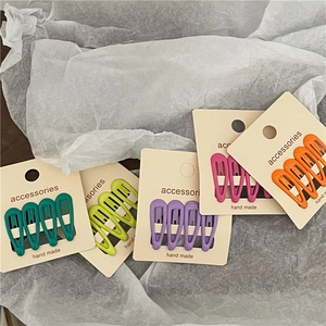 Detail of colorful matte drop-shaped BB hair clips on accessory display cards