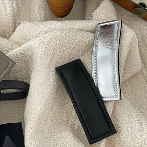 Minimalist rectangular PU leather hair clip in matte black and metallic silver finishes