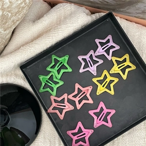 Detailed view of ten colorful glittery star-shaped hair clips in pastel tones
