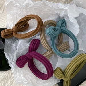 Close-up of ribbed fabric texture and twist knot detail on colorful elastic hair ties