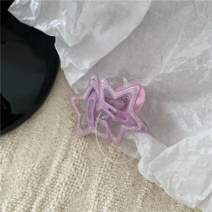Macro shot of a lavender star-shaped glitter BB hair clip with sparkling resin finish