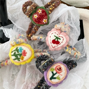 Detailed close-up showing textured woolen yarn knit patterns on sweet cross hair claws