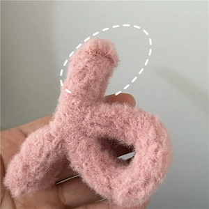Detailed view of the pink plush faux fur texture on the winter claw hair clip