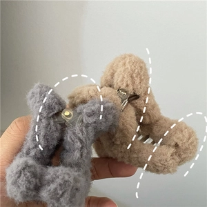 Close-up of grey and khaki plush teddy bear hair claws with soft faux fur texture