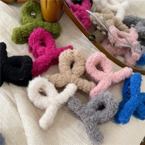 Plush faux fur hair claw clips in various colors like green and pink for winter styling