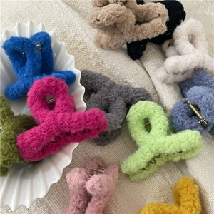 Detail view of assorted colorful plush hair claw clips made of soft teddy fleece fabric
