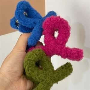 Three plush faux fur hair claw clips in blue, pink, and green for autumn and winter