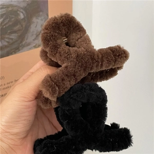 Close-up of brown and black plush faux fur cross hair claws for cozy winter styling
