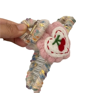 Cute wool felt hair claw clip featuring pink plush flower and cherry embroidery for women