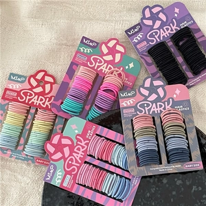 Detail of high-elastic baby hair ties in colorful sets on branded cards