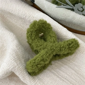 Detail view of the soft green faux fur plush hair claw clip and durable metal spring