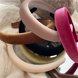 Thick velvet padded headbands in various vintage colors shown with a retro wooden mirror